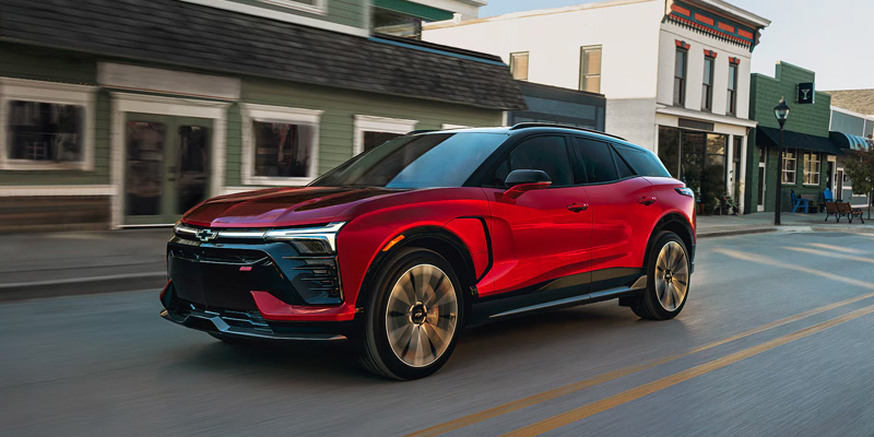 A Chevrolet blazer ev driving down a city street in Orlando, FL, showcasing its sleek design and urban environment.
