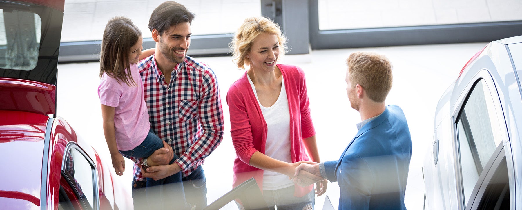 Dealership employee talking to customers